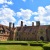 a large brick building with a lawn in front of it