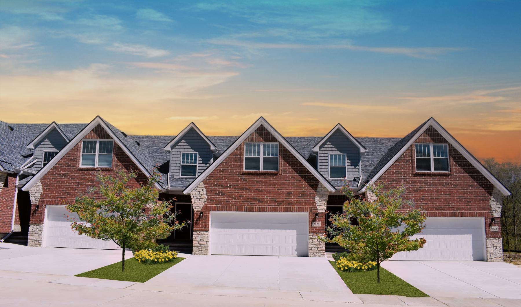 a row of houses with driveways